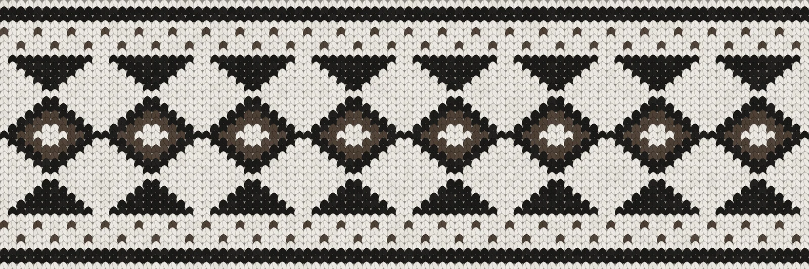 A knitted band of yoke pattern in white, black and brown: rows of dots, triangles pointing down, diamonds with brown hearts and triangles pointing up