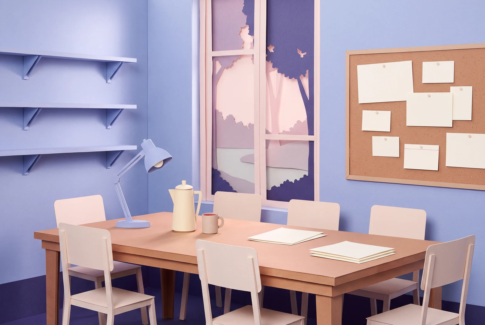 A small editorial room made of cut paper: a long wooden table with pale chairs, a desk lamp, a coffee pot and two stacks of pages, empty shelves, a cork board of blank cards and a tall window onto pink trees